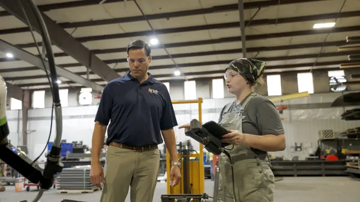 WHP Trainingtowers COO Joe Kirchner talking to employee in warehouse